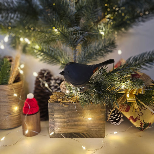 Hand-painted Gray Catbird wooden clip-on ornament attached to a Christmas tree branch, showing spring clip mount and fine feather detail — Painted Bird Shop.