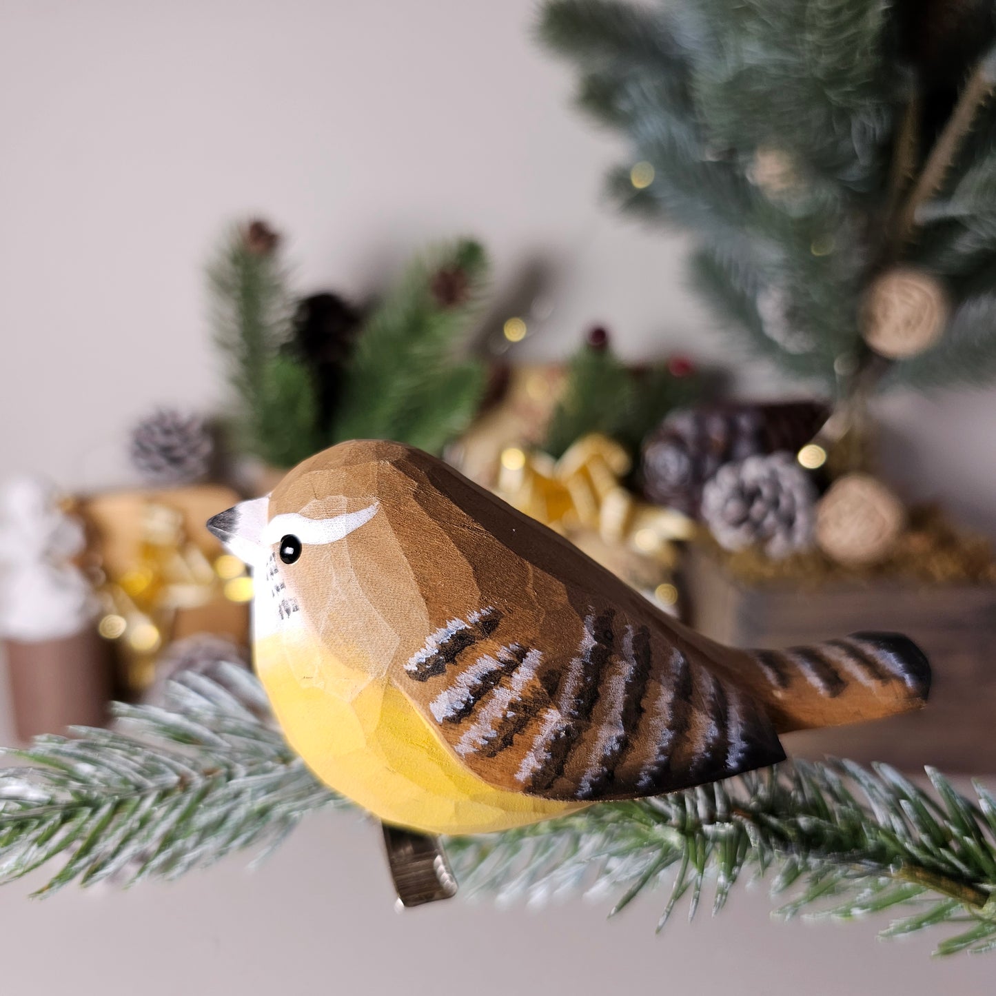 Hand-carved solid basswood Carolina Wren clip-on ornament showing rich rufous upperparts, bold white eye stripe, and upright cocked tail — by Painted Bird Shop.