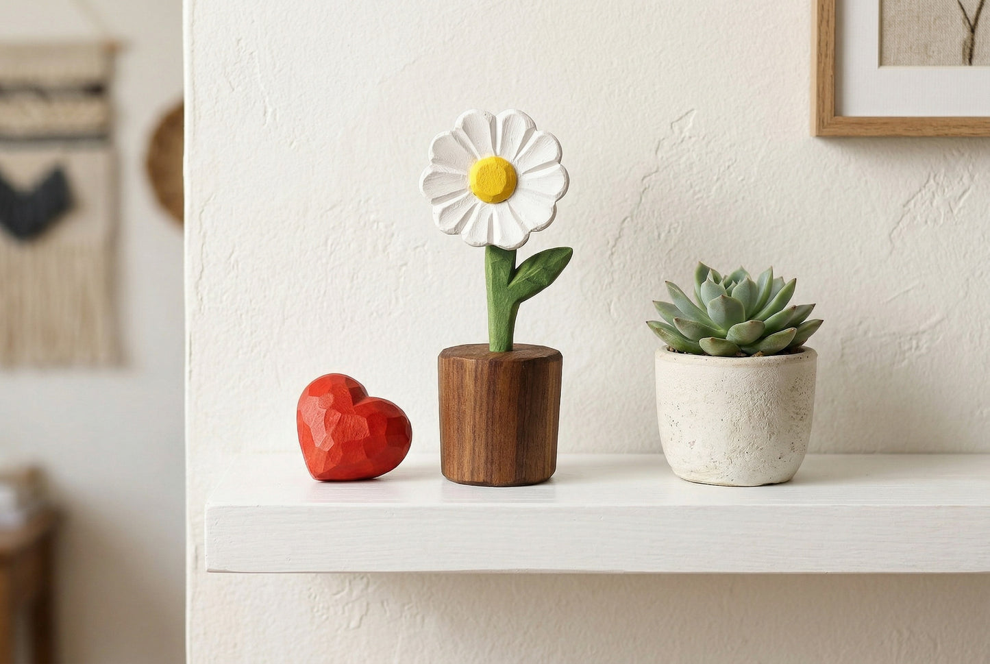 Decorative items including a flower-shaped object, a heart-shaped object, and a small potted plant on a shelf.