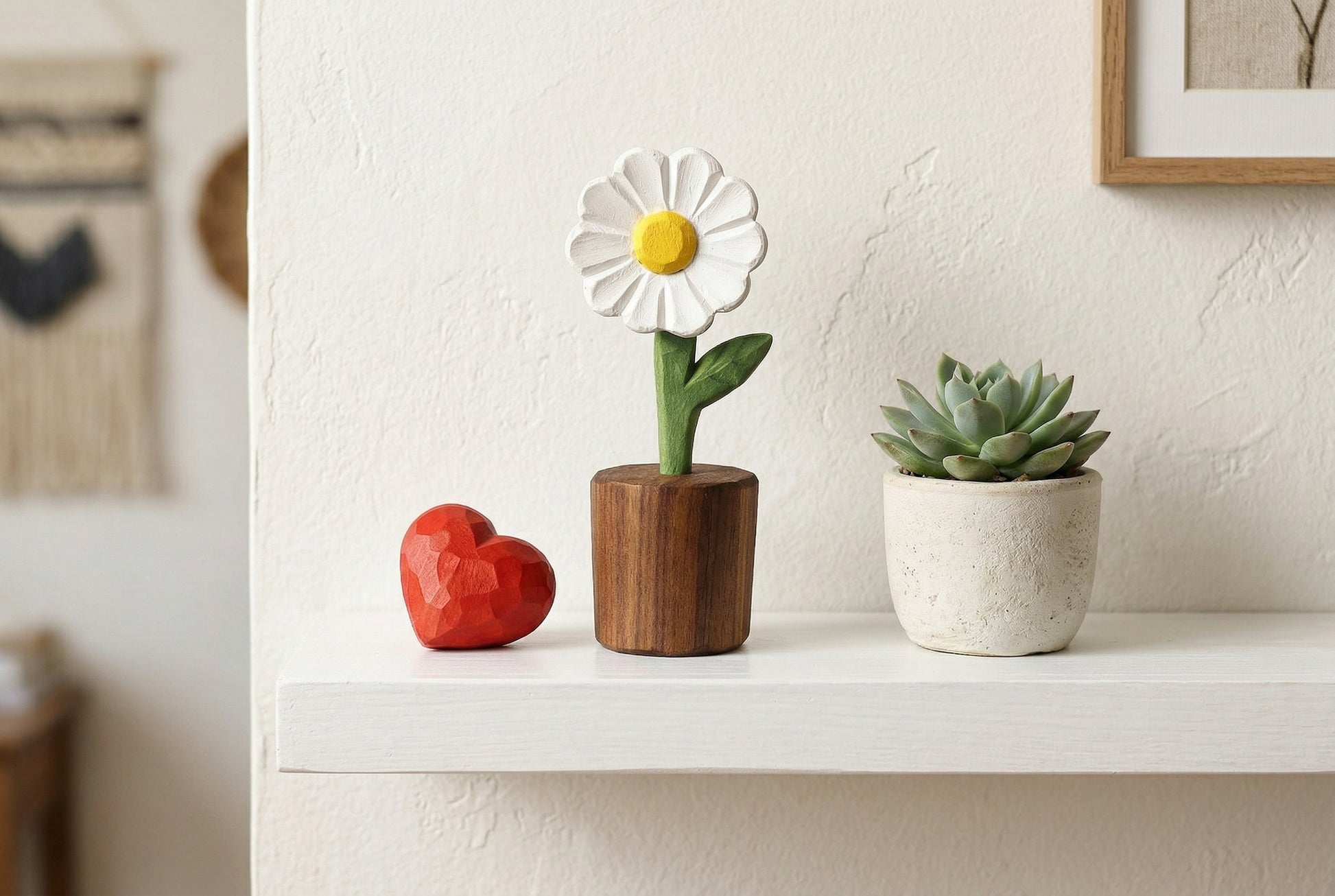 Decorative items including a flower-shaped object, a heart-shaped object, and a small potted plant on a shelf.