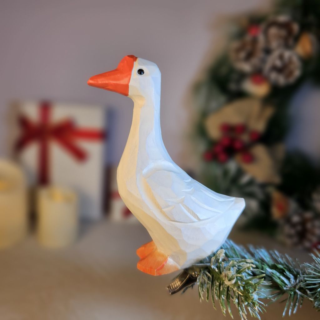 Hand-carved solid basswood Emden Goose clip-on ornament showing pure white plumage, bright orange bill, and upright dignified stance — by Painted Bird Shop.