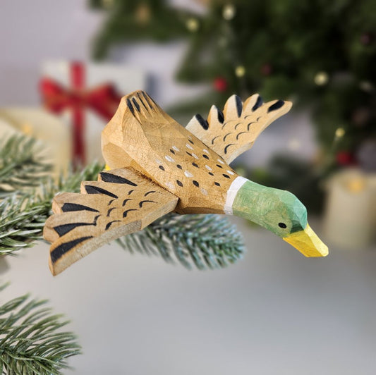 Hand-carved solid basswood Mallard clip-on ornament showing iridescent green head and chestnut breast detail, displayed on a pine branch