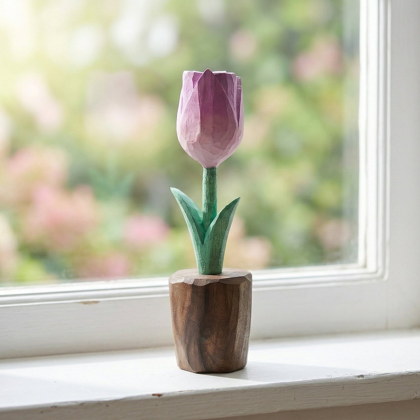 Wooden tulip sculpture on a windowsill with a blurred garden background