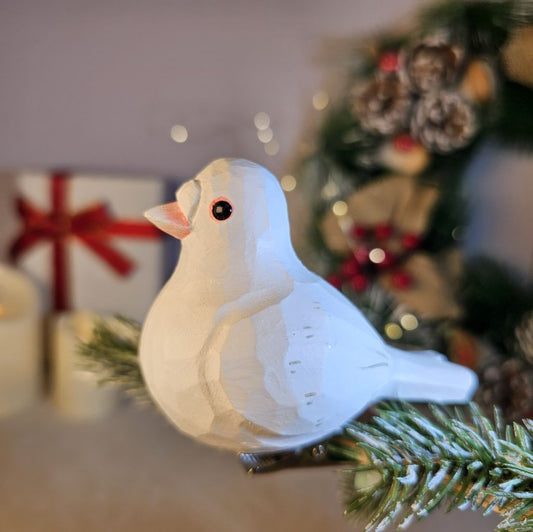 White wooden Pigeon clip-on ornament hand-painted from solid basswood, clipped to a Christmas wreath with green foliage background